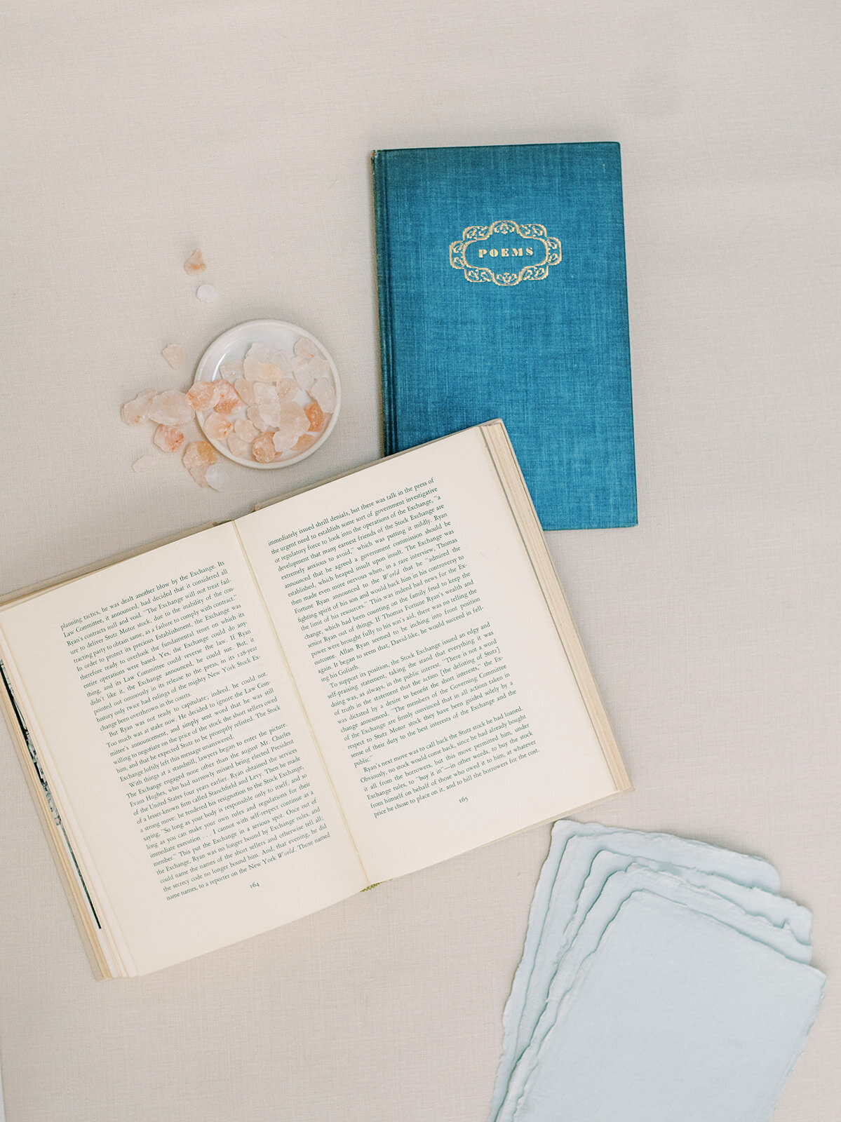 A flatlay with a poem book and pink salt, used to portray a website copywriting service