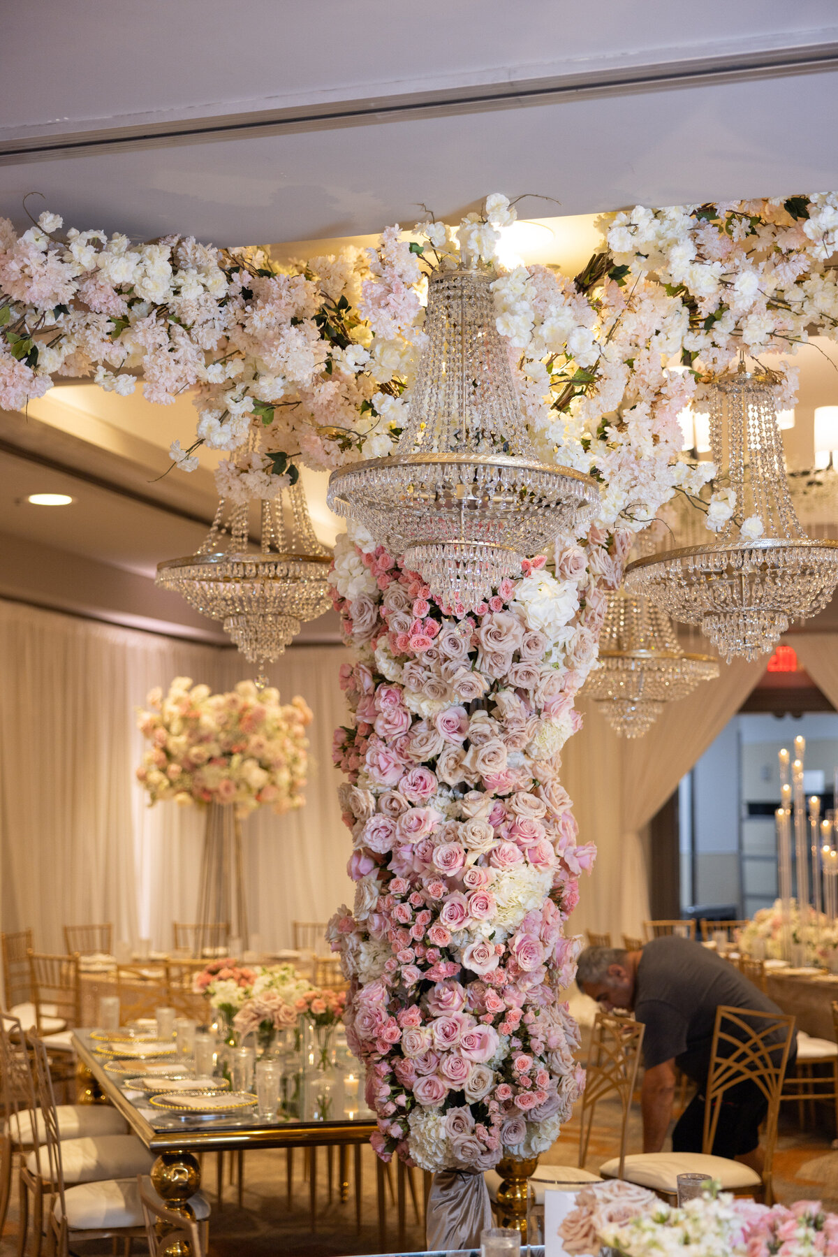 A pillar covered in pink and white flowers