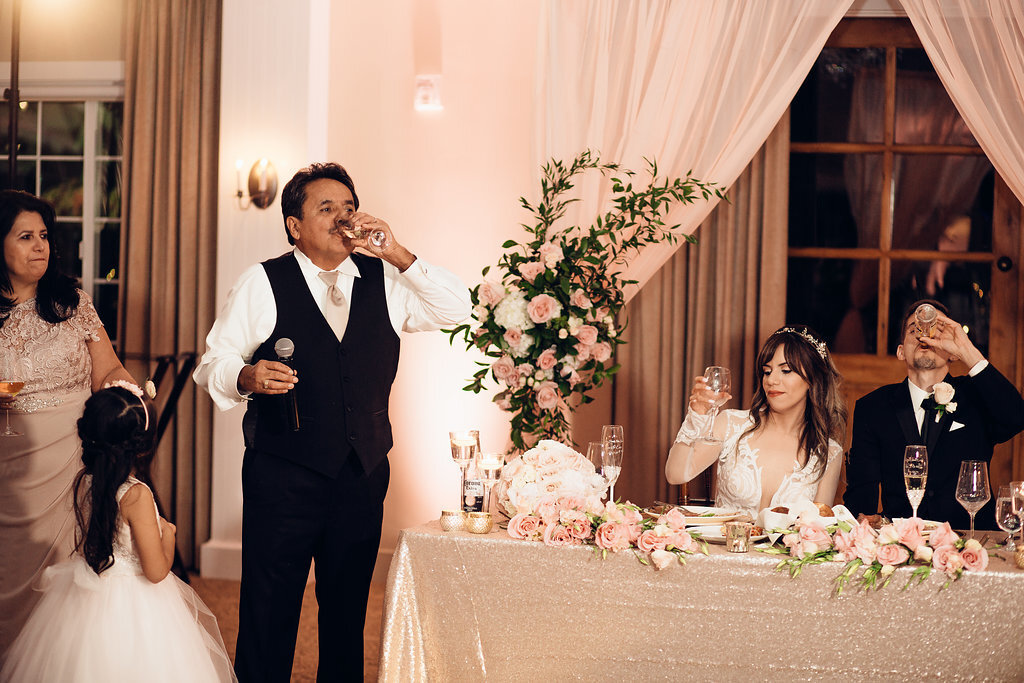 Wedding Photograph Of Man In Black Suit Drinking From His Wine Glass Los Angeles