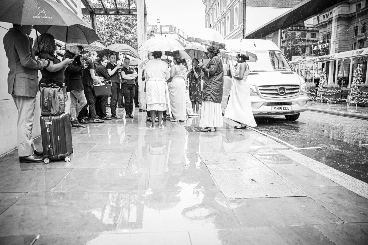 Wedding Party shelters from the rain