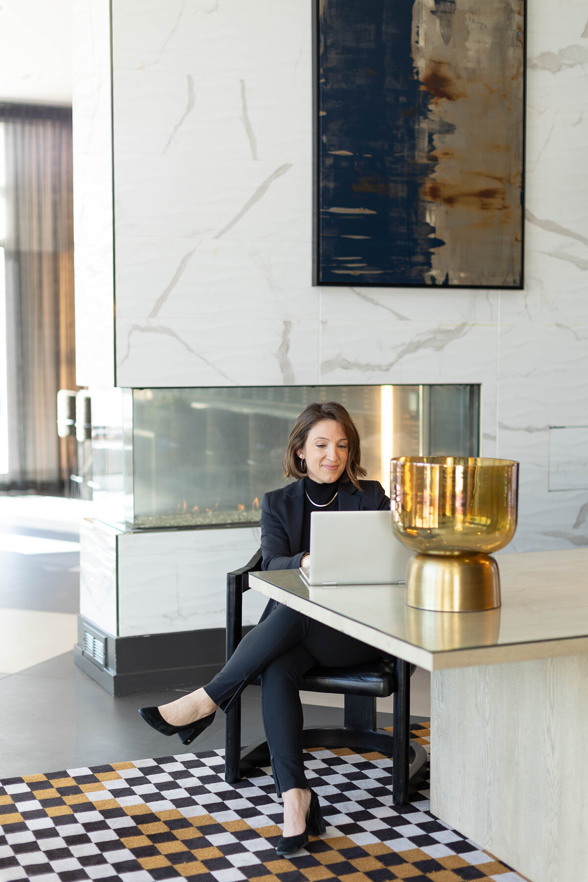 woman on laptop in an art deco room