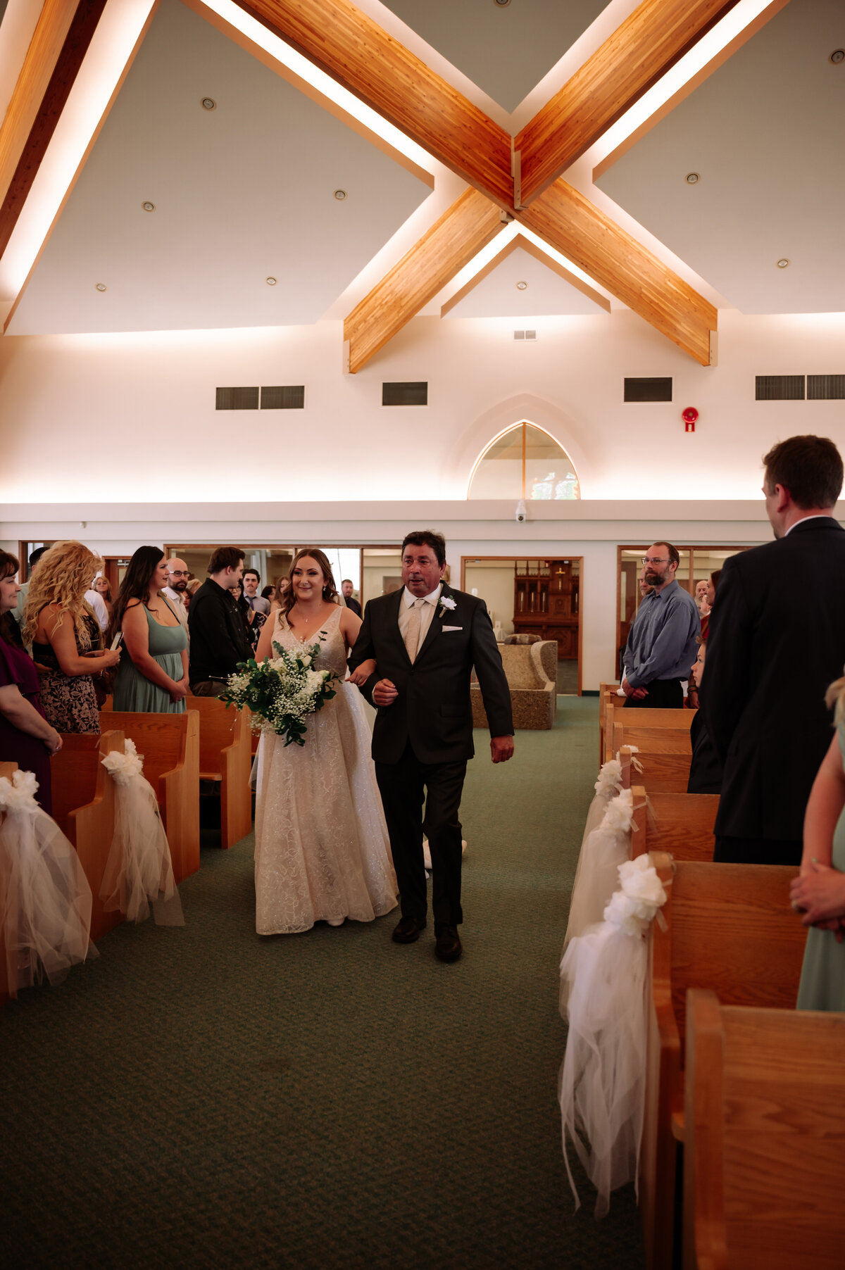 bride walking down the aisle of a church on wedding day