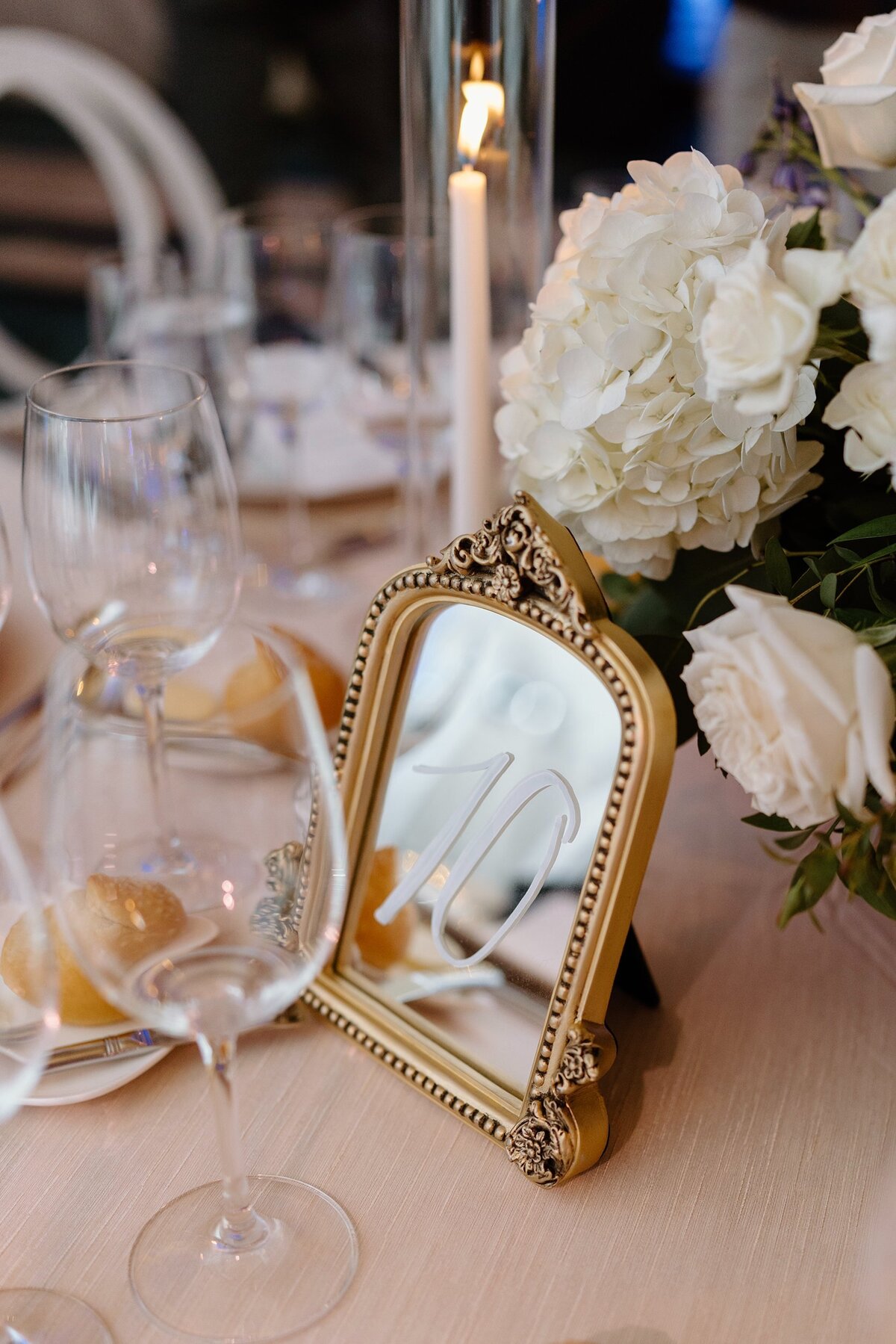 5x7 and 8x10 gold mirrors with ornate decor on the top and calligraphy for table number