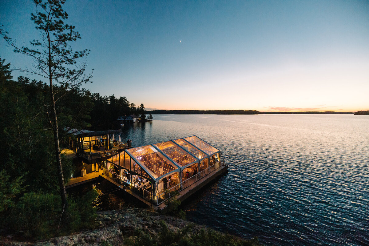Arial view of a stunning tent built on the water in muskoka