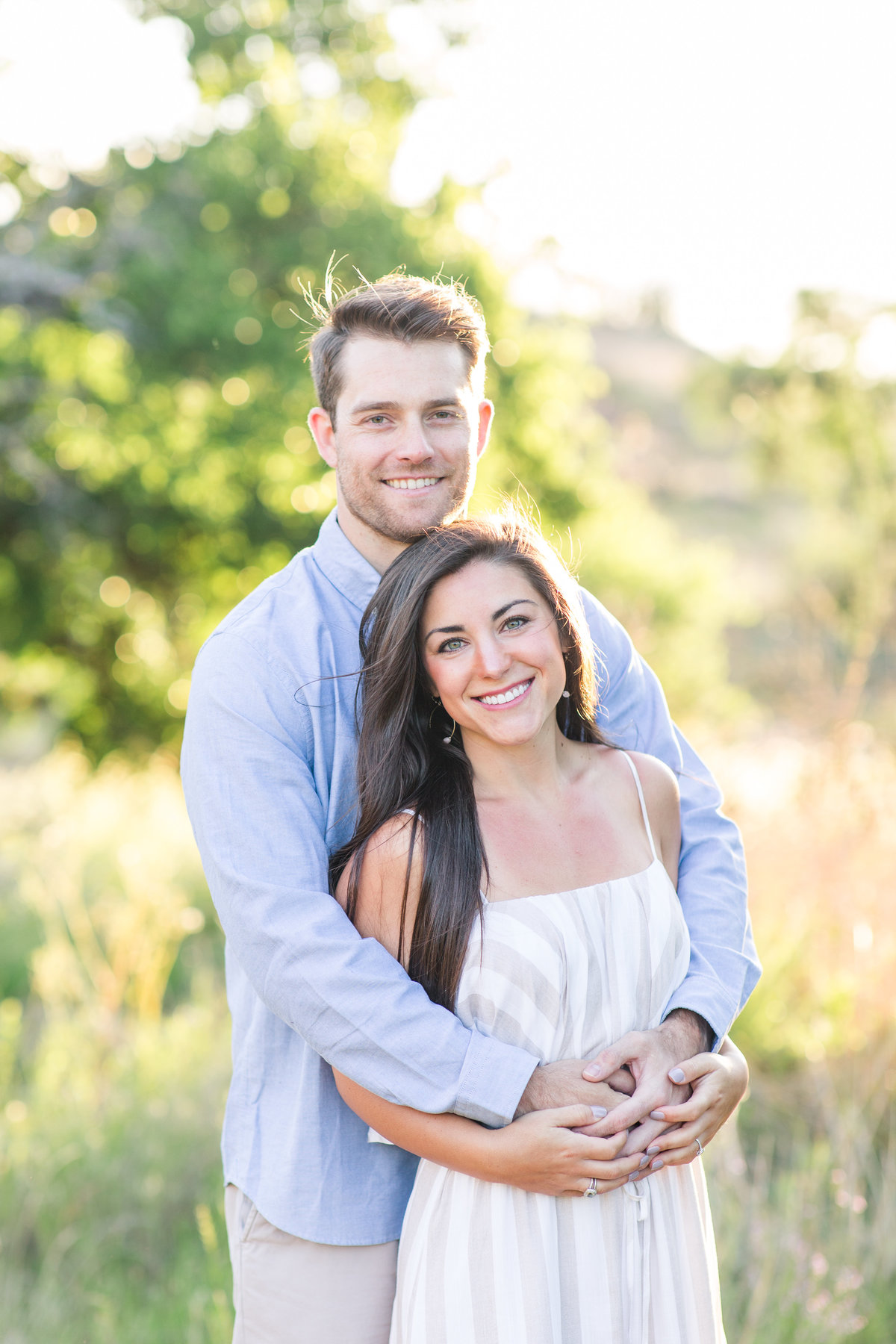 Engagement photos of couple embracing at Enchanted Rock; Fredricksburg, Texas