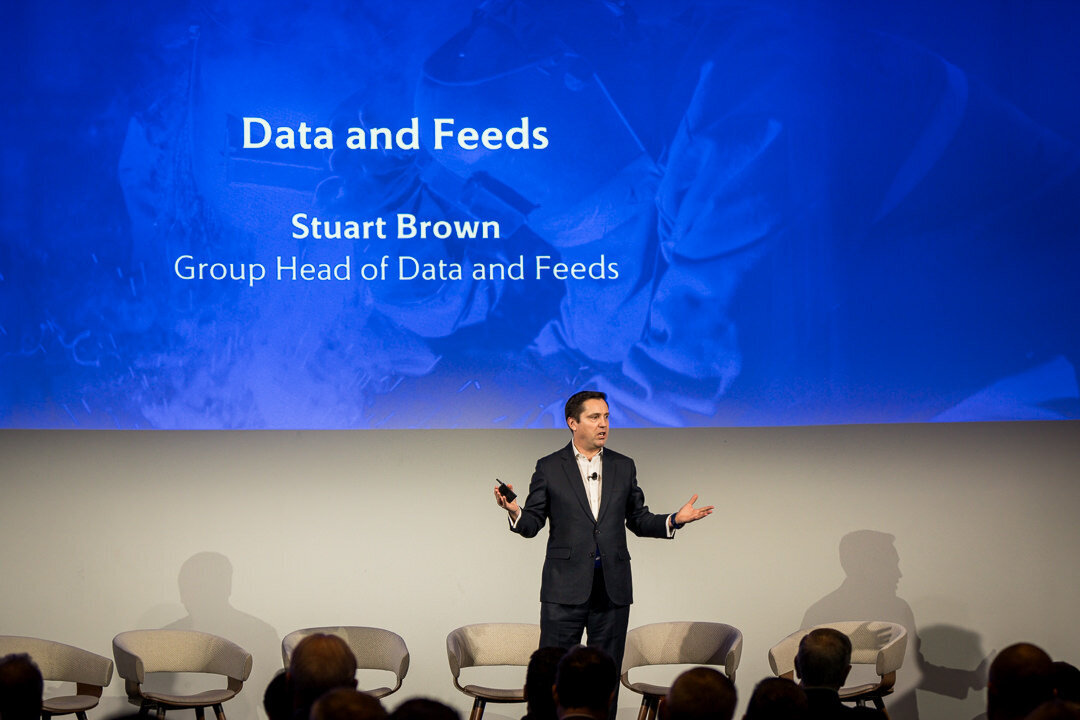 Corporate event photography of speaker presenting slides during large conference on professional stage new jersey.