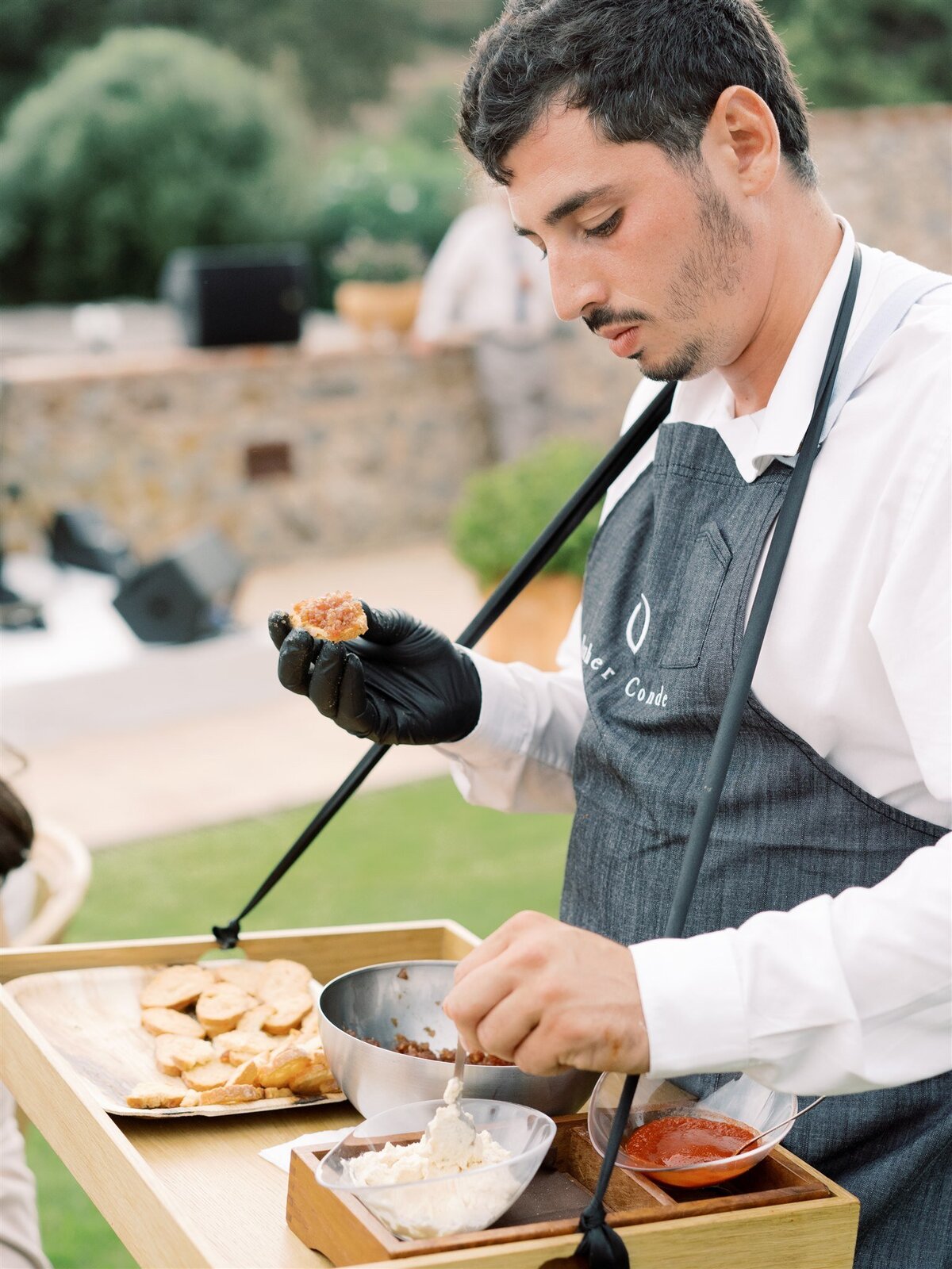 Waiter serving appetizers outdoor wedding cocktail Mas Torella