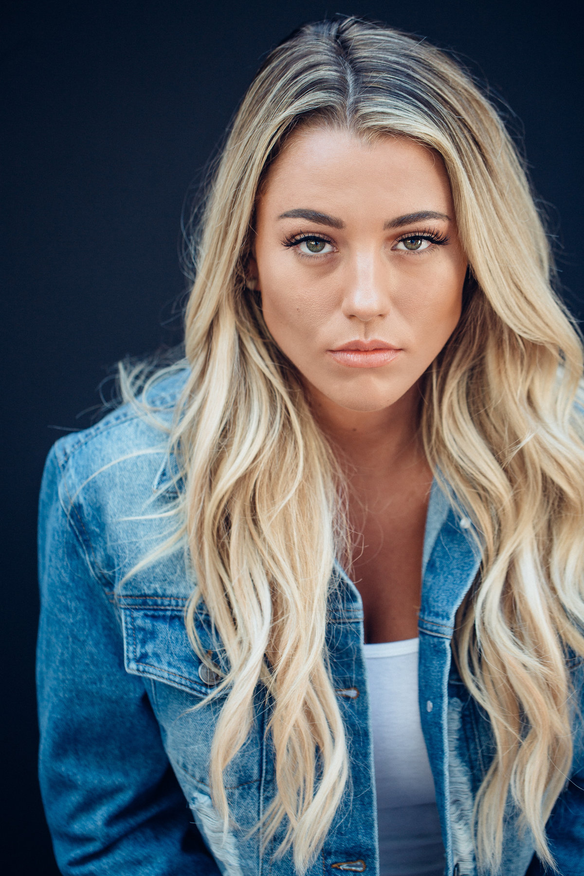 Headshot Photograph Of Young Woman In Outer Blue Denim Jacket And Inner White Shirt Los Angeles