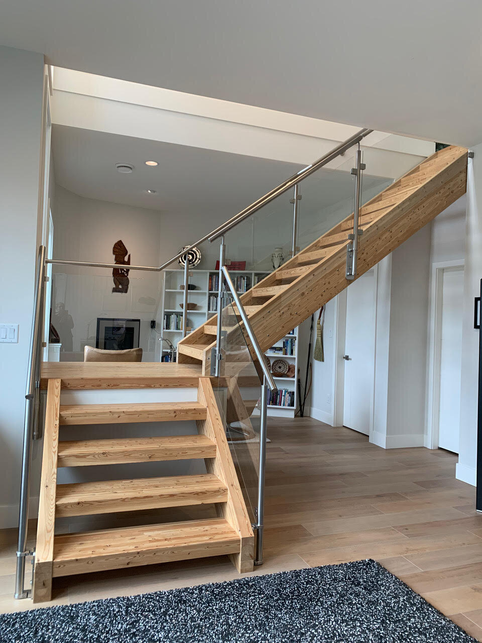 Modern stairwell design with hardwood and steel railings.