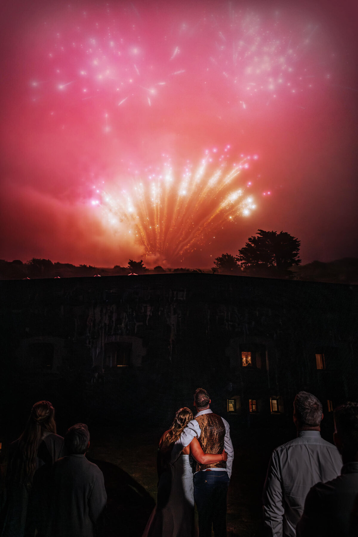 A group of people standing in front of a firework