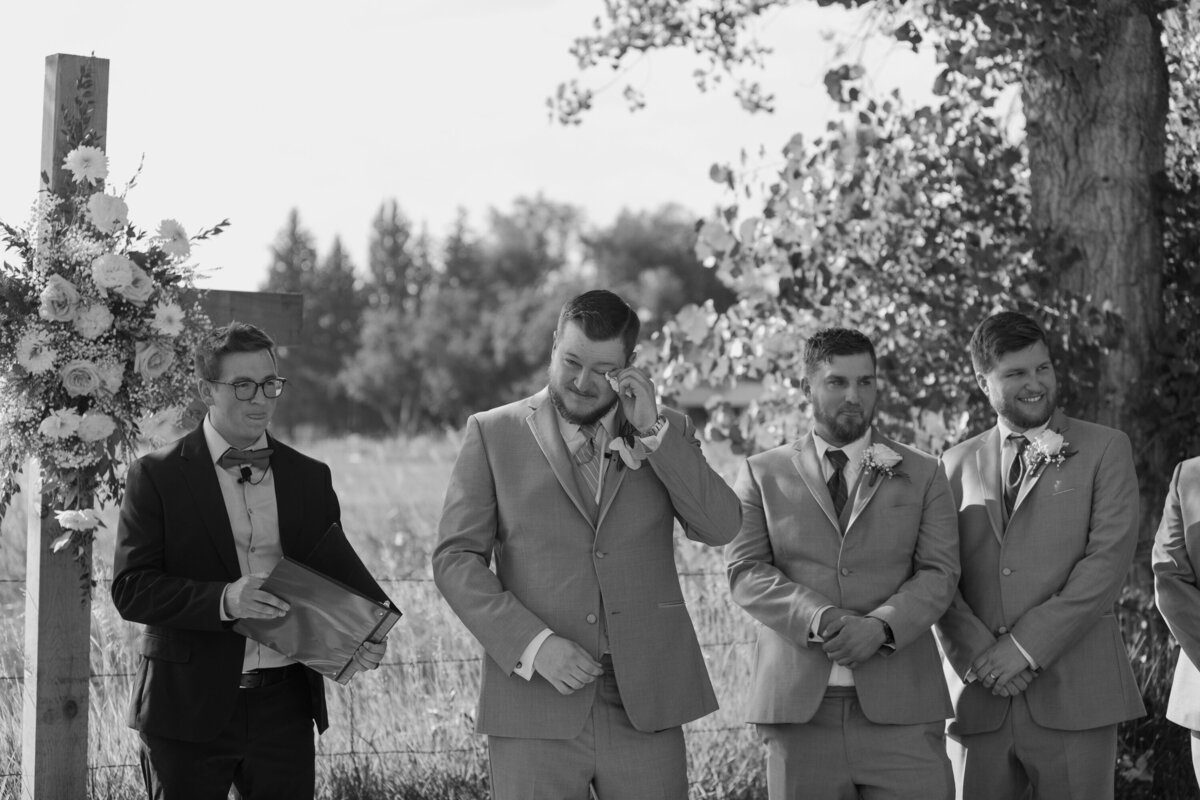 A groom wipes tears from his eye during his Colorado Wedding.