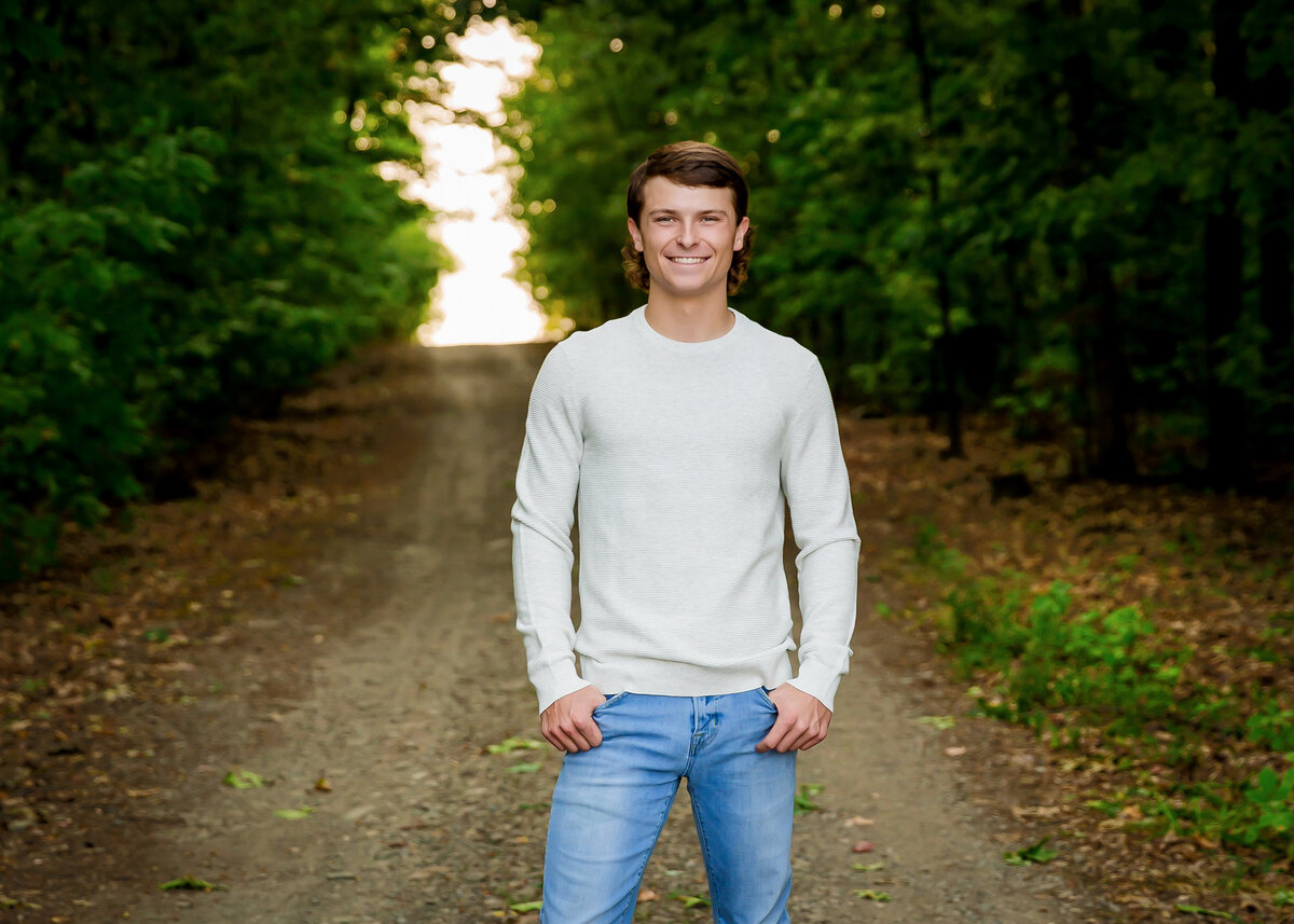 Senior guy dressed casual outfit for his photos with path in Penn Yan NY