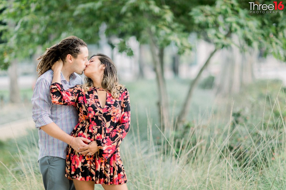 Steamy kiss between engaged couple