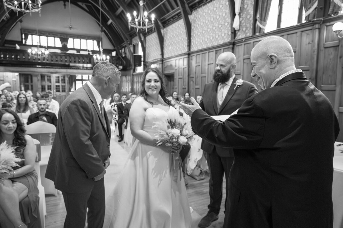 Bride and groom exchanging vows in Worsley Court House ceremony room.