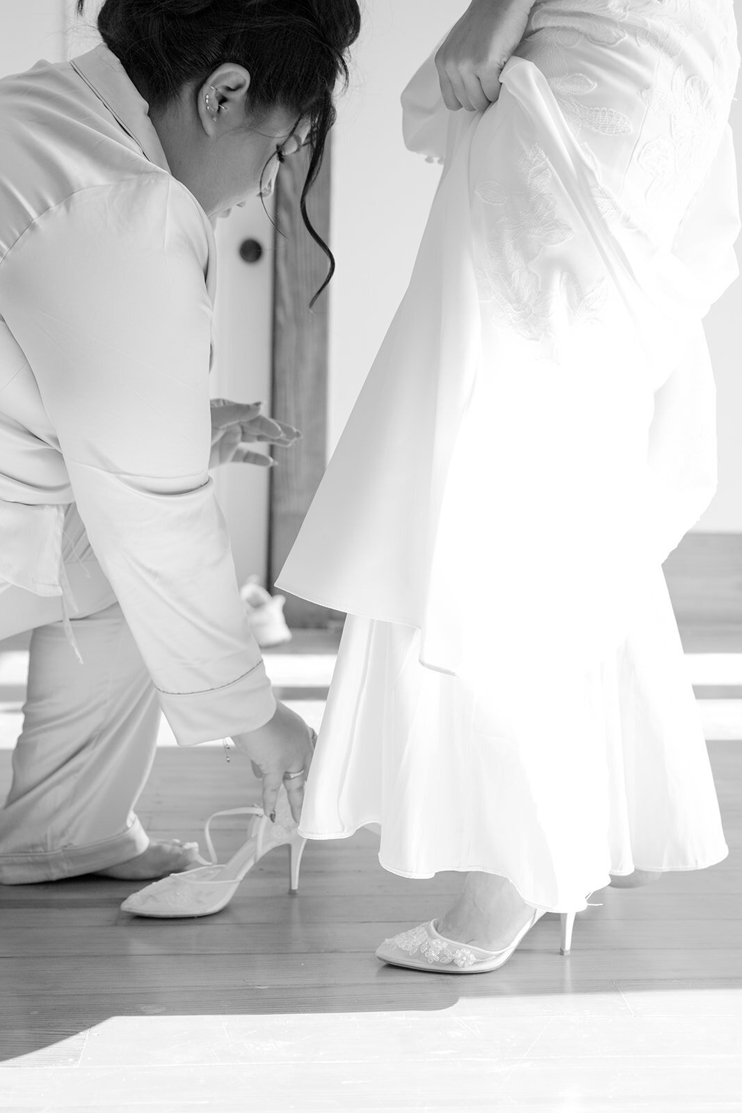 Bride stepping into designer shoes inside a grand estate, captured with editorial movement in San Antonio