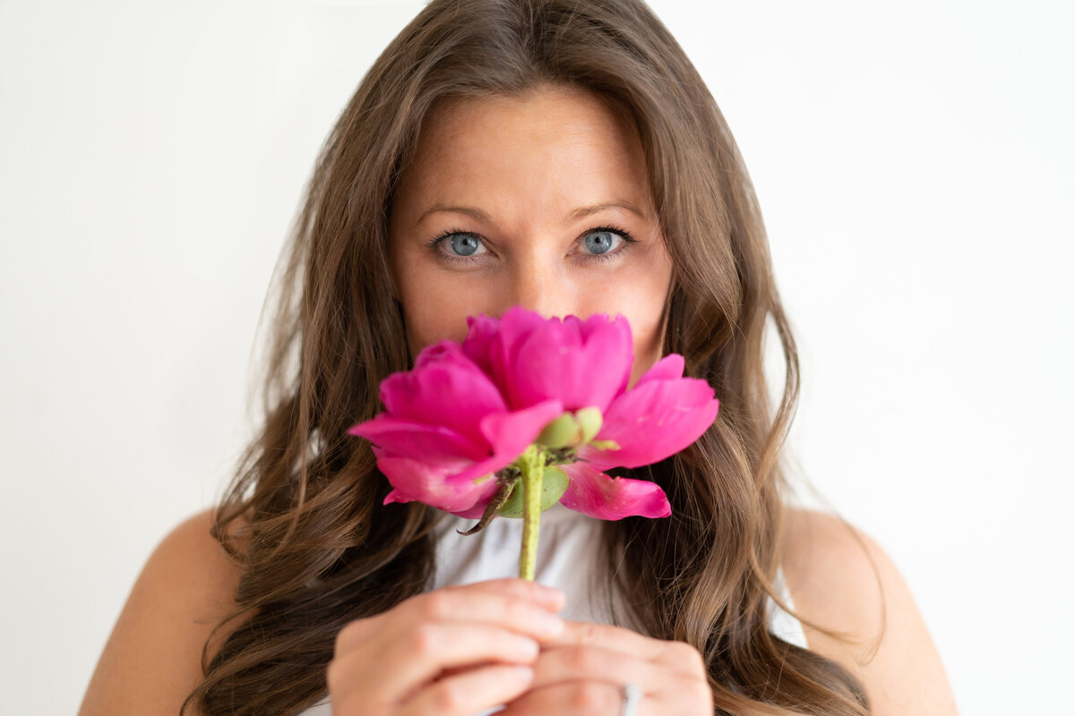 woman-holding-pink-flower