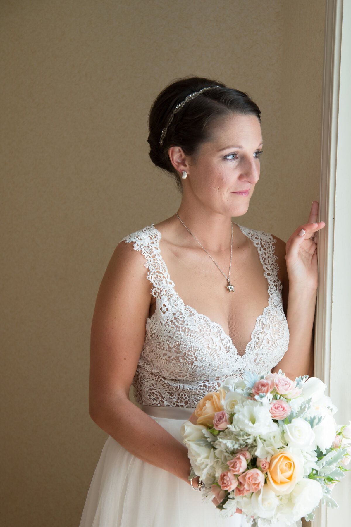 Bride before her wedding looking out the window