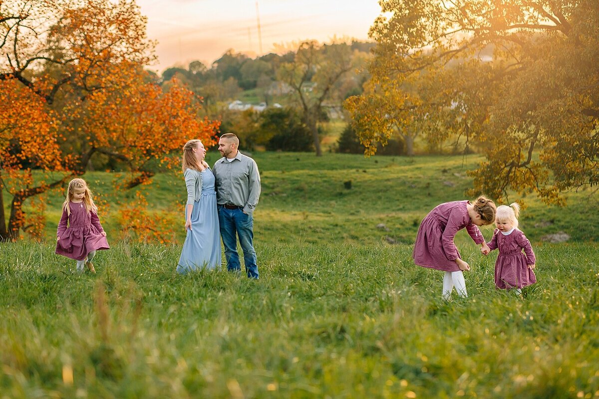 Family in a field at sunset getting family pictures near Charlottesville, VA