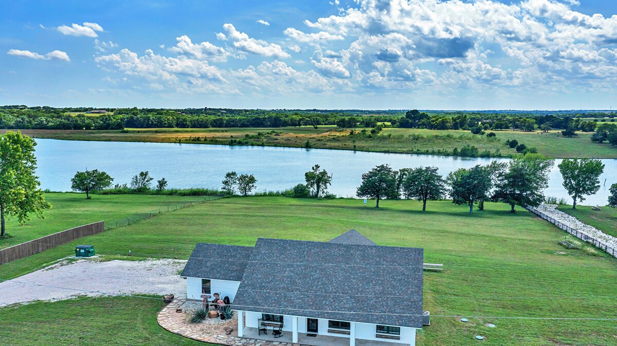 View from above of this three-bedroom, 2-bathroom vacation lake house for 10 guests with free wifi, dock access on private lake, fishing, bunk room, huge yard in close proximity to Magnolia, Baylor and downtown Waco, TX.