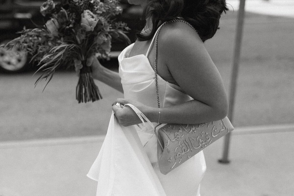 Woman in modern wedding dress with flowers in black and white