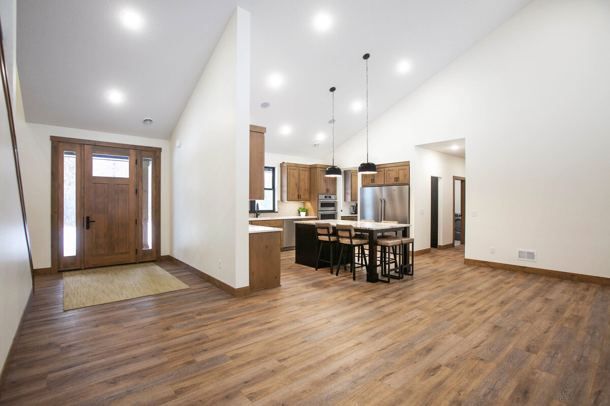Light-filled entryway with wood flooring and neutral tones in a custom-built Elk River home
