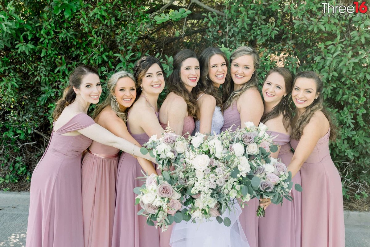 Bride and Bridesmaids pose with bouquets together
