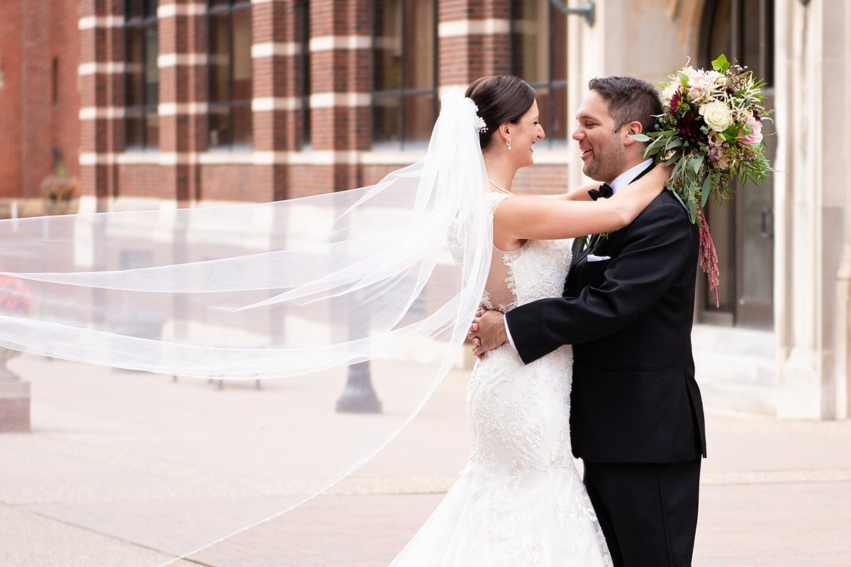 Bride with long veil and Groom at Duquesne University in Pittsburgh, PA