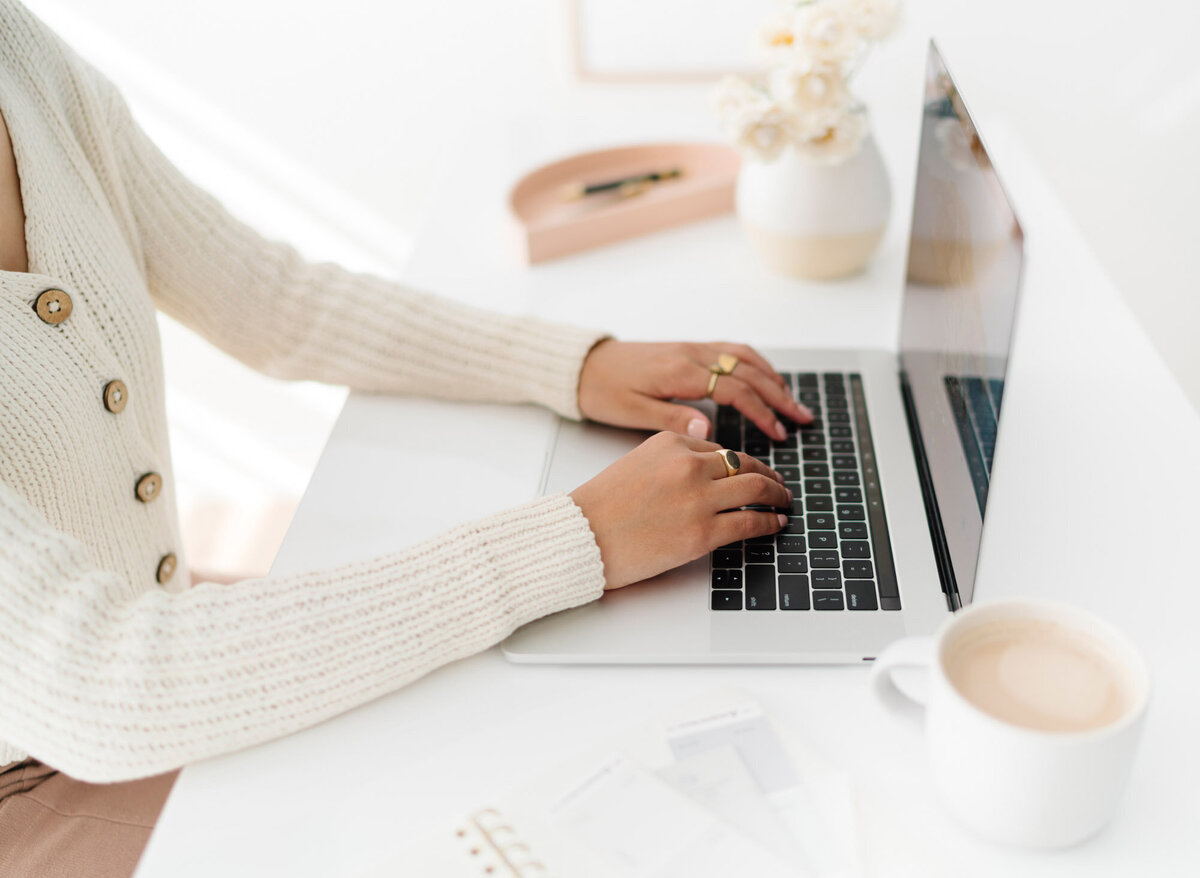 Woman typing on macbook