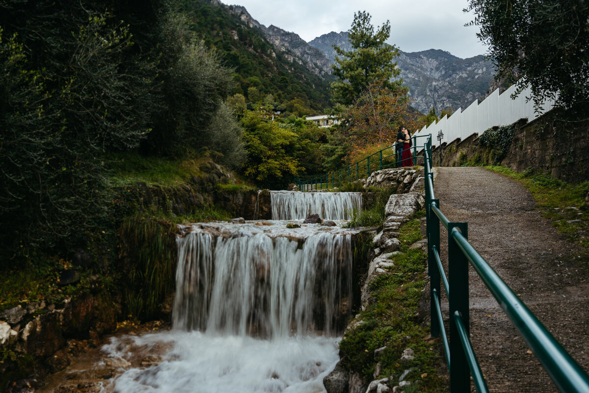 Small cascading waterfall along mountain path near Lake Garda
