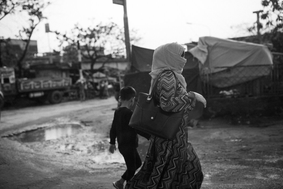 Gesluierde vrouw met haar zoon op de straten van Dhaka Bangladesh