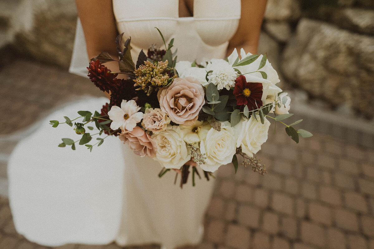 intimate wedding photography photo of bride holding her bouquet in her alena leena bridal gown