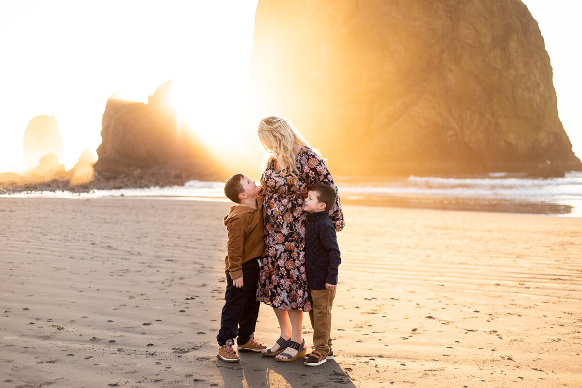 Mother and sons on beach at sunset on the Oregon Coast
