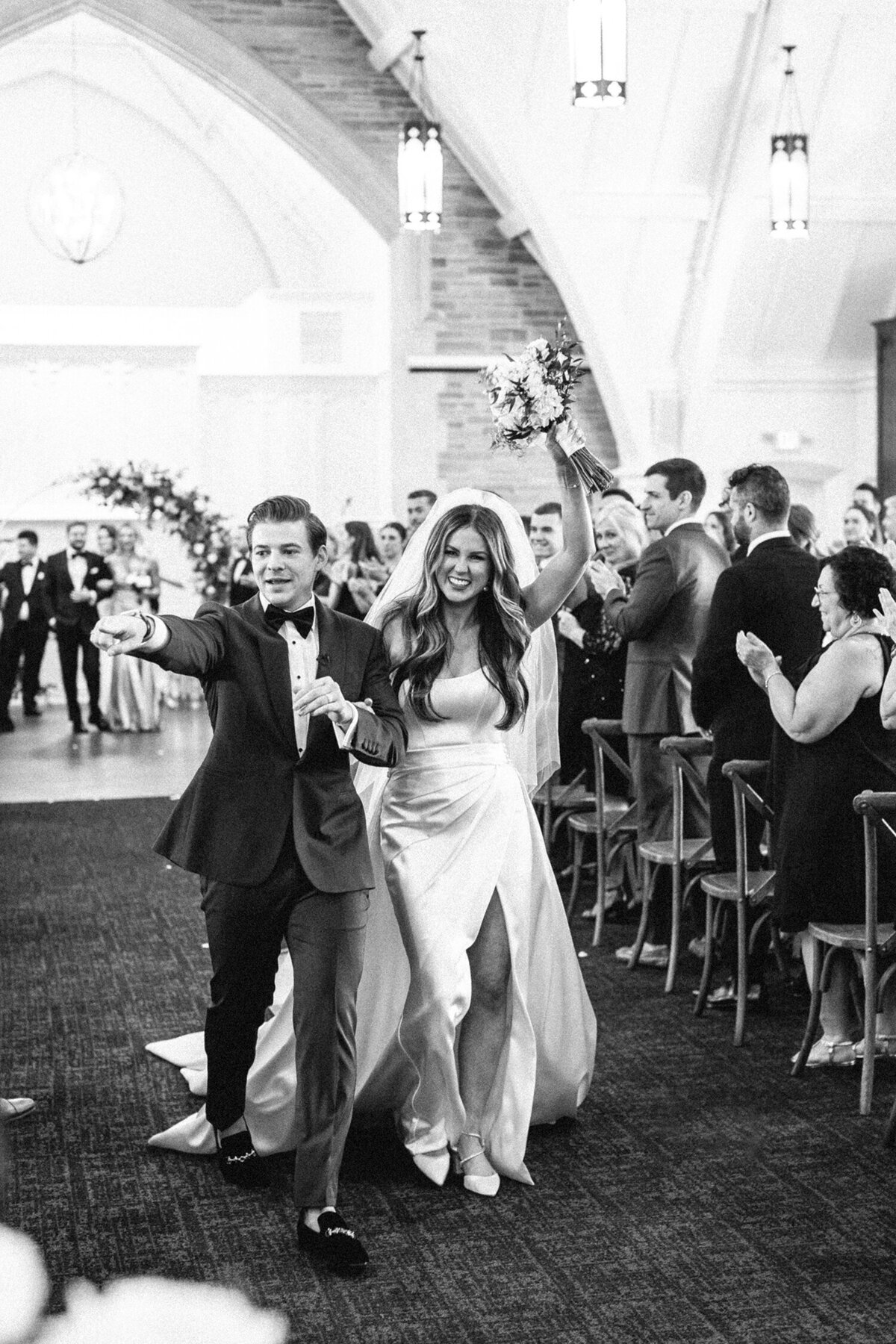 Bride and groom walking down the aisle, cheering