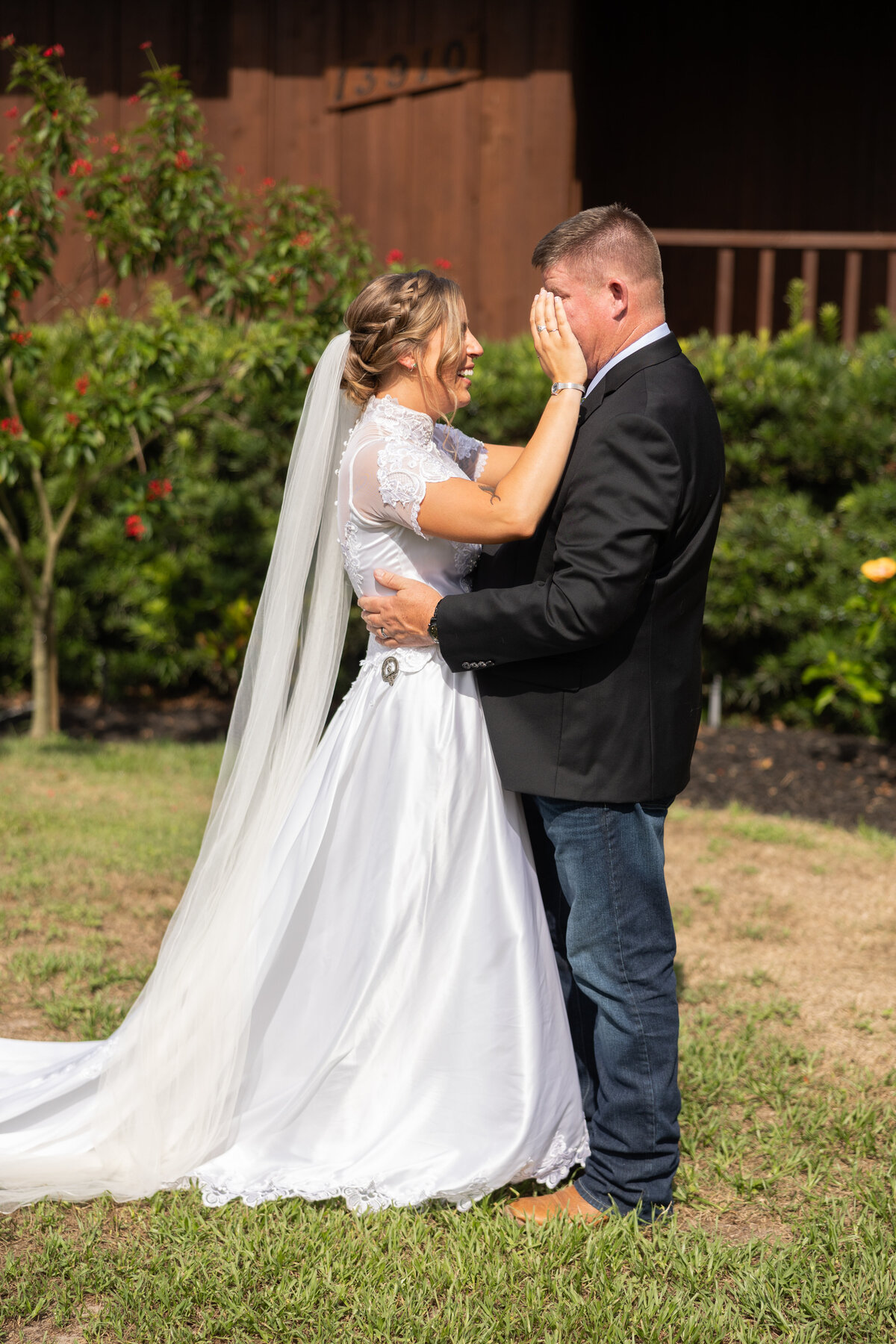 father of the bride and bride crying during first look at Cypress Creek Farmhouse in Astatula Florida by Florida wedding photographer Amanda Richardson Photography