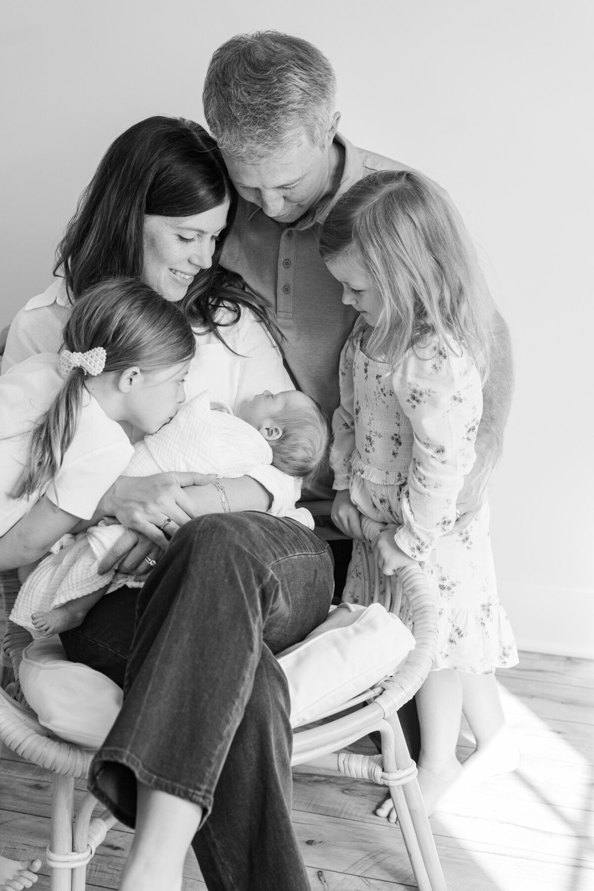 A heartfelt close-up of a family holding their newborn close, sharing a moment of love and connection