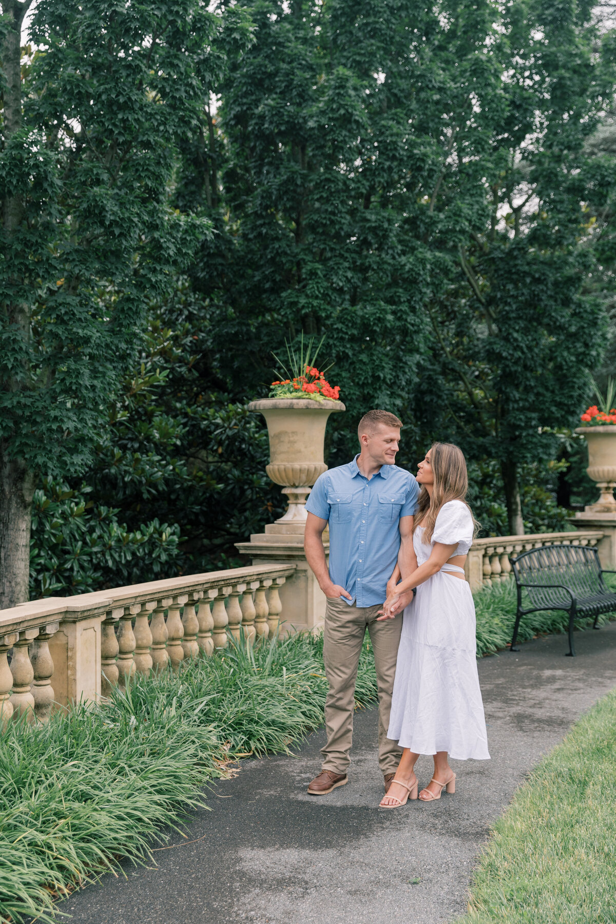 Couple walking through gardens for their engagement session