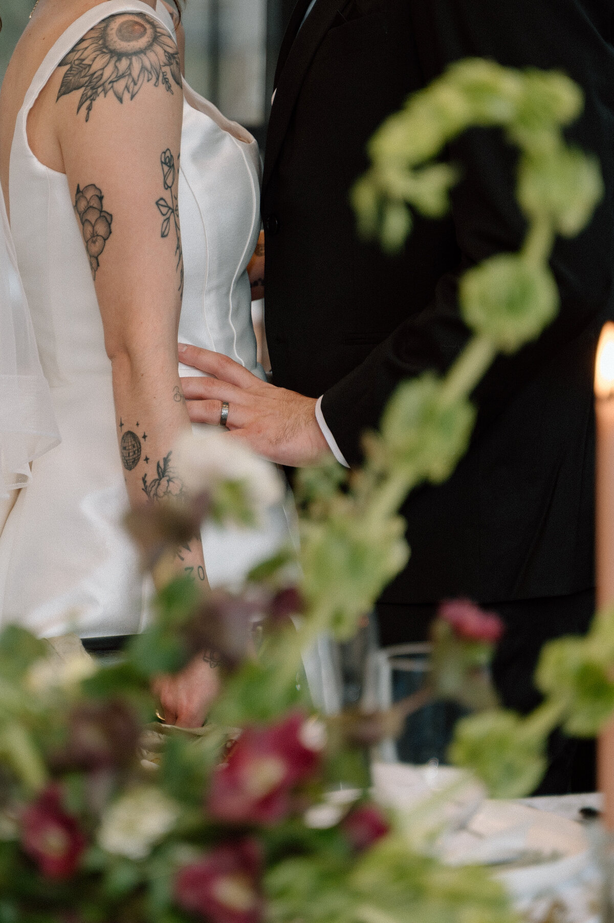 Groom’s hand gently placed on bride’s back during a documentary moment captured in Banff.