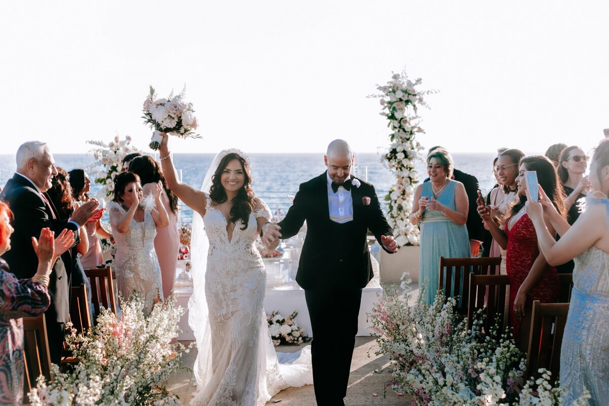 High end wedding  at the Alia Marea Resort in San Diego multi culture photo of bride and groom walking down the isle by Laura Shepard Photography