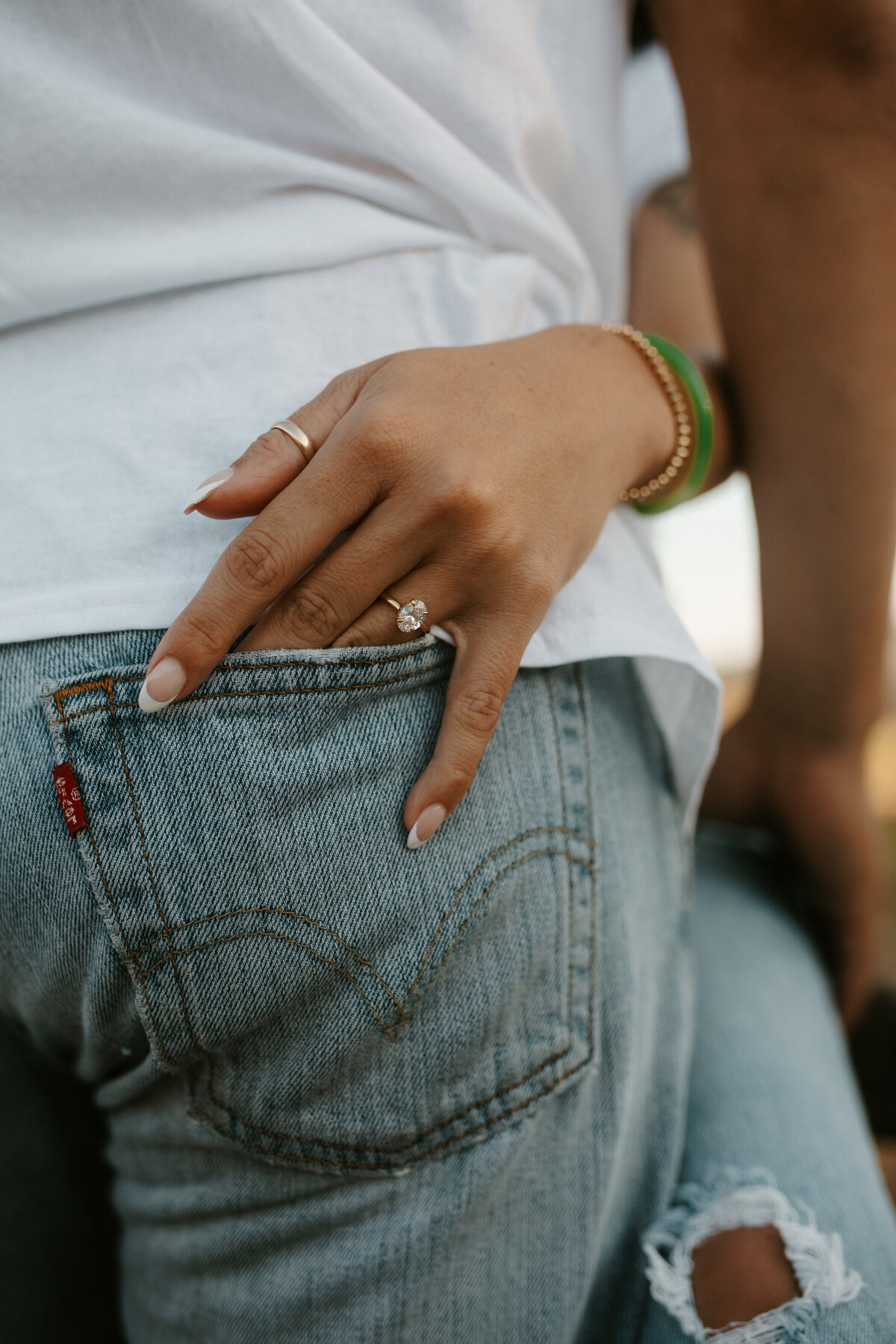 engagement ring photo she has her hand in his back pocket showing off her ring