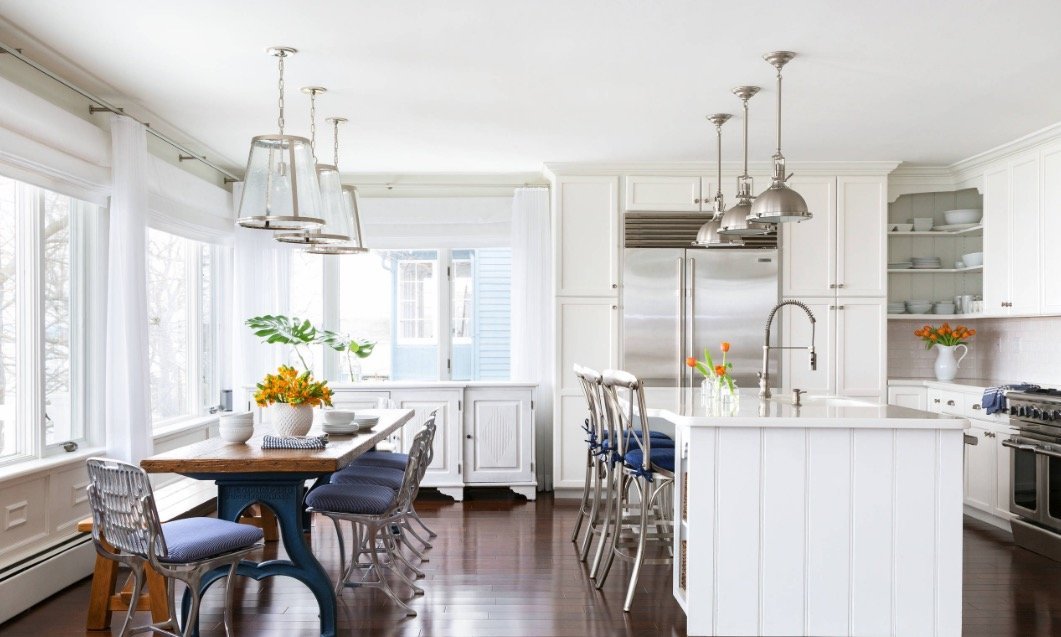this is a beautiful white kitchen remodel with island and hardwood floors