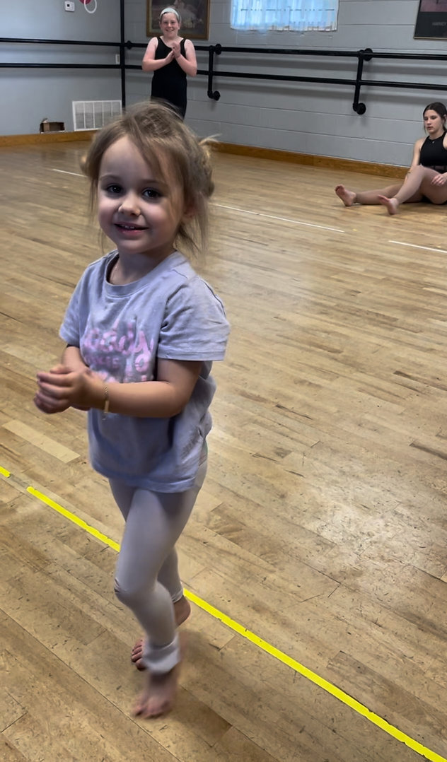 one of the little girls helping the velocity team stretch