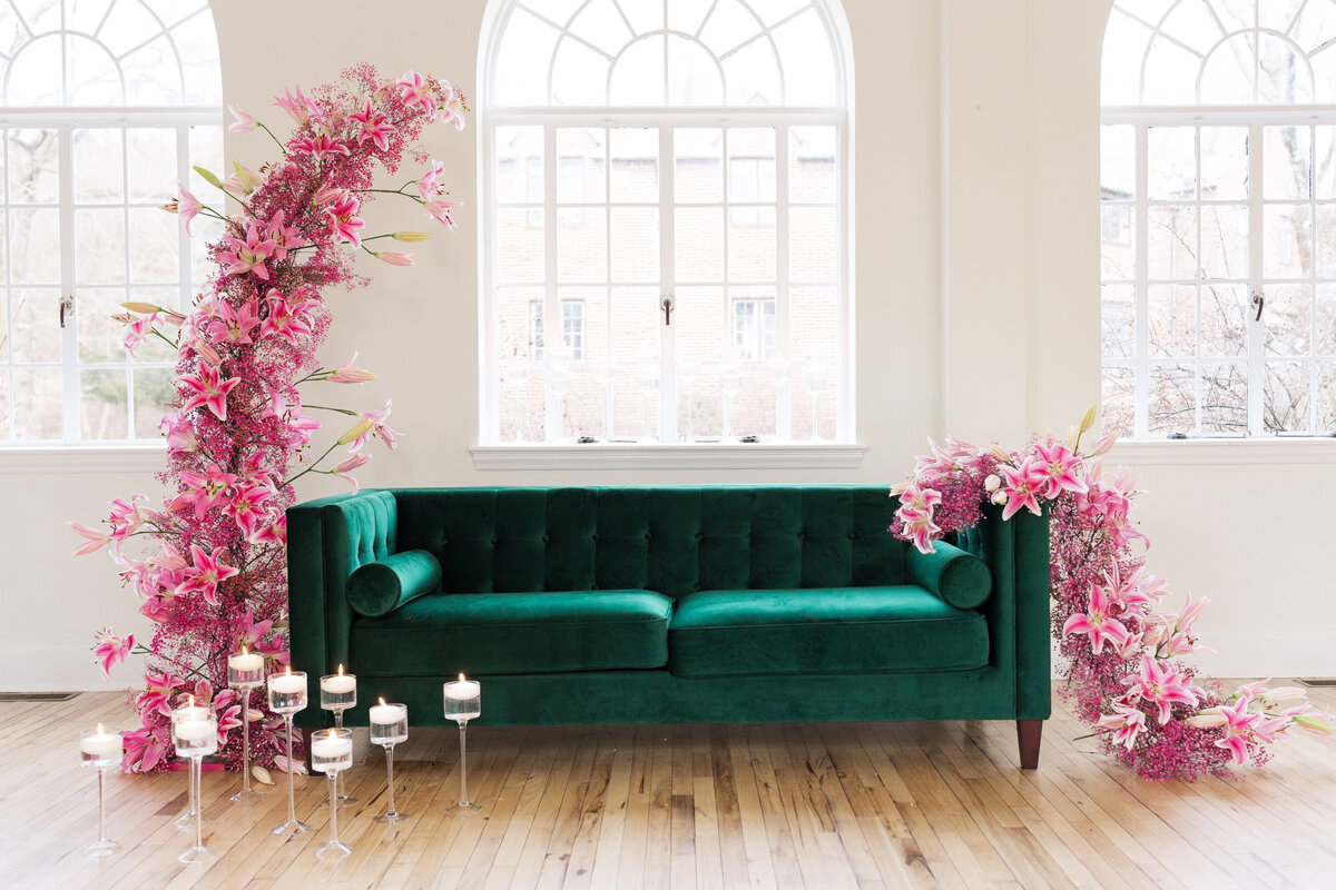 emerald sofa with pink florals and floating candles