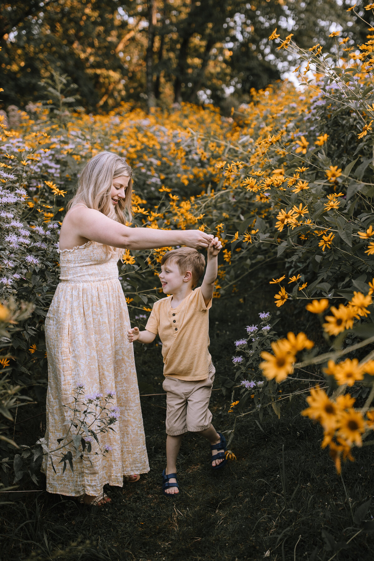Mom dancing with her son in a flower garden at Robin Hill Park.