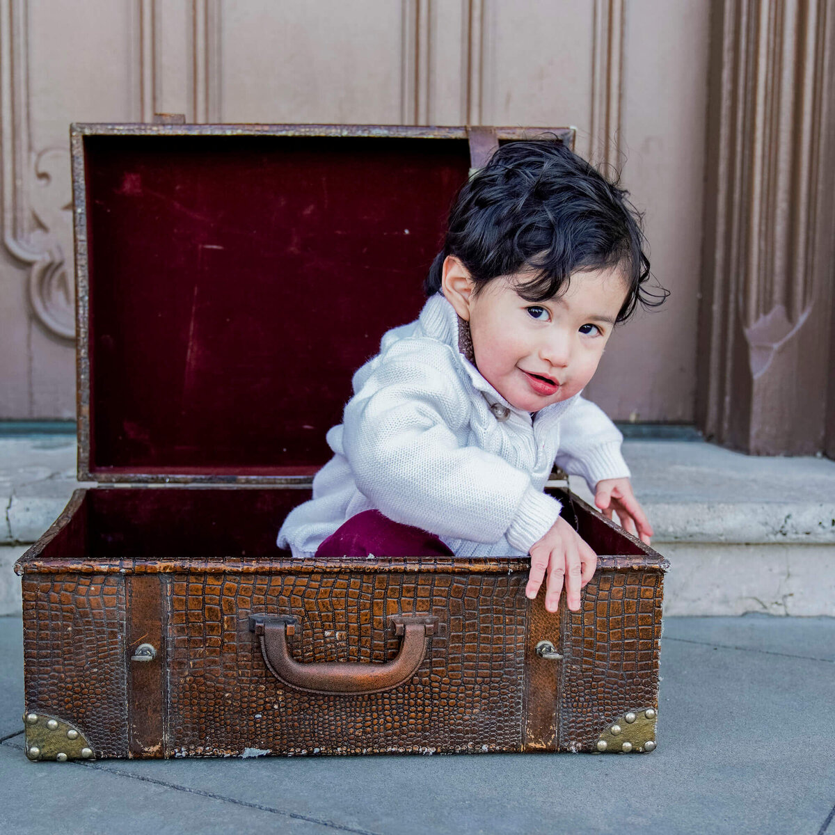 denver co family photographer - young child sitting in suitcase