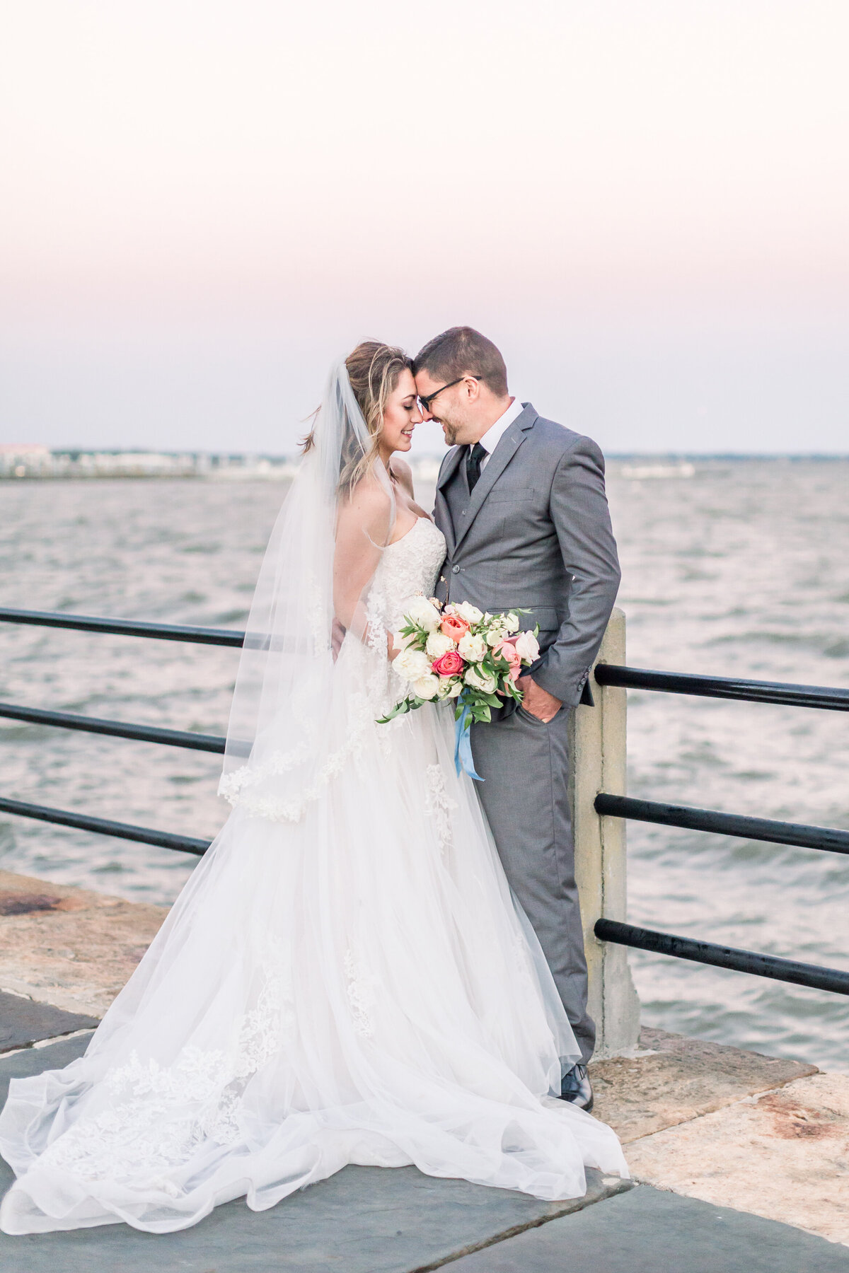 Bride and groom celebrate on dock of Charleston in South Carolina by Karen Schanely