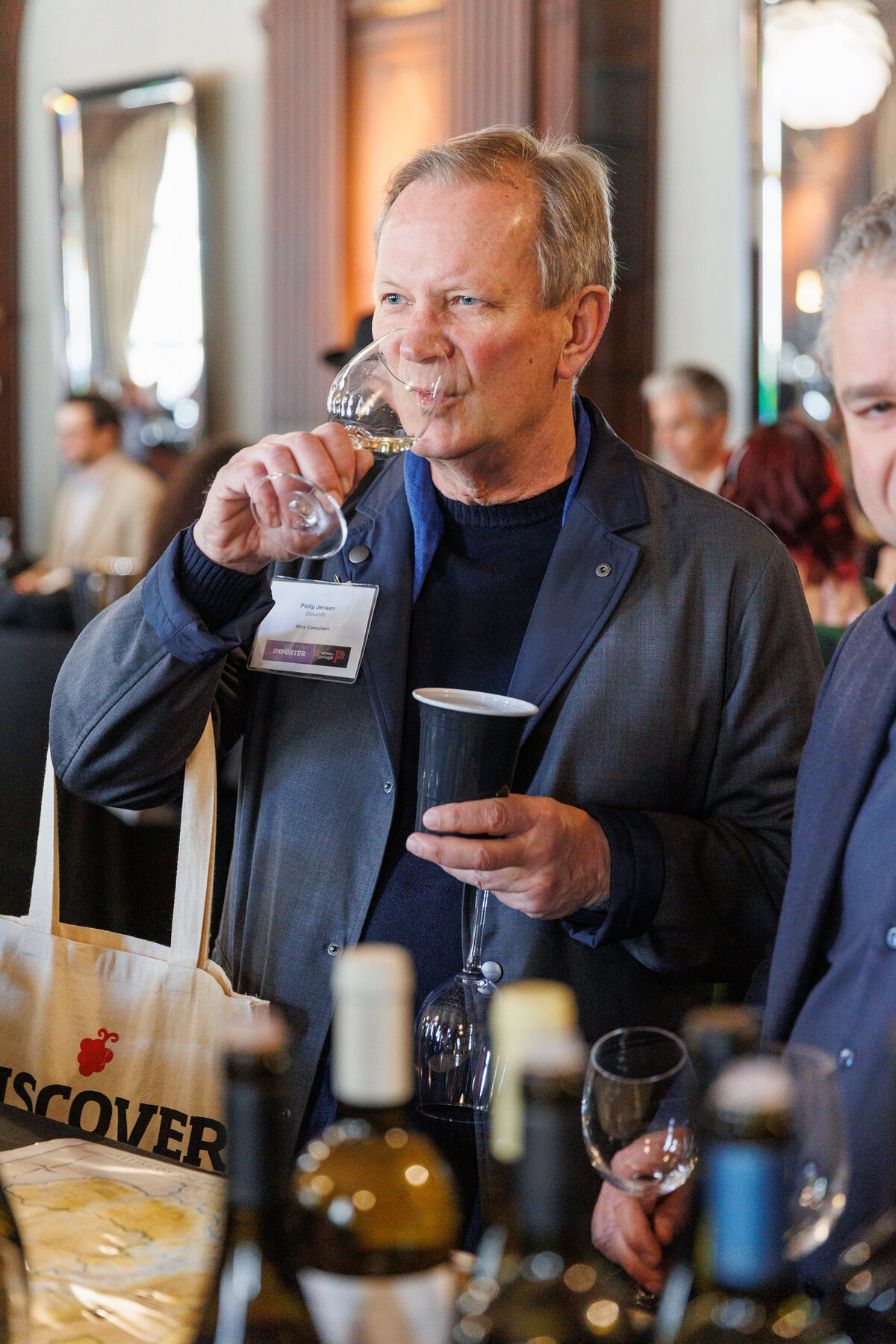 Older male holding a glass of Portugal wine