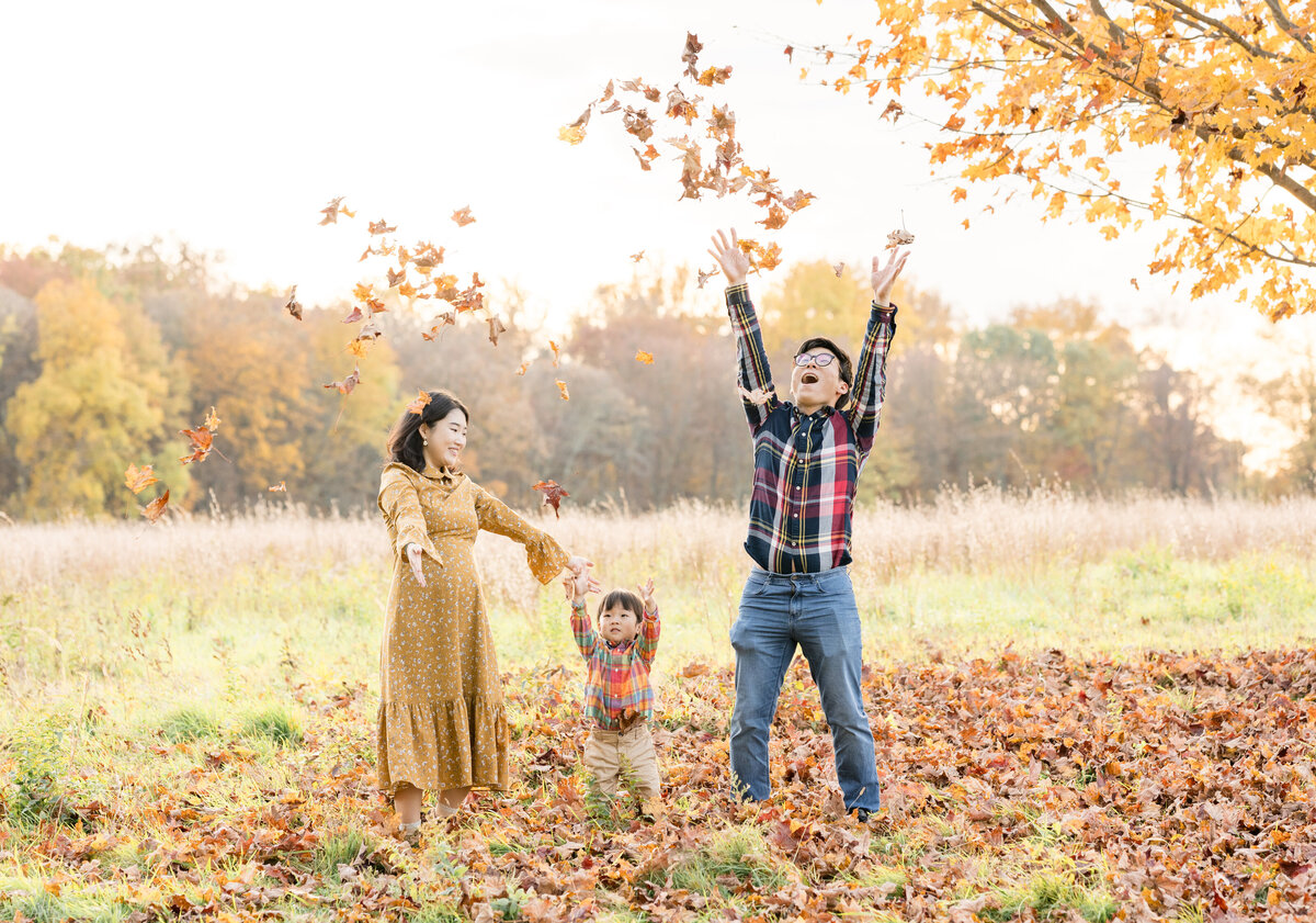 Family playing in leaves during family photoshoot in New Canaan, CT