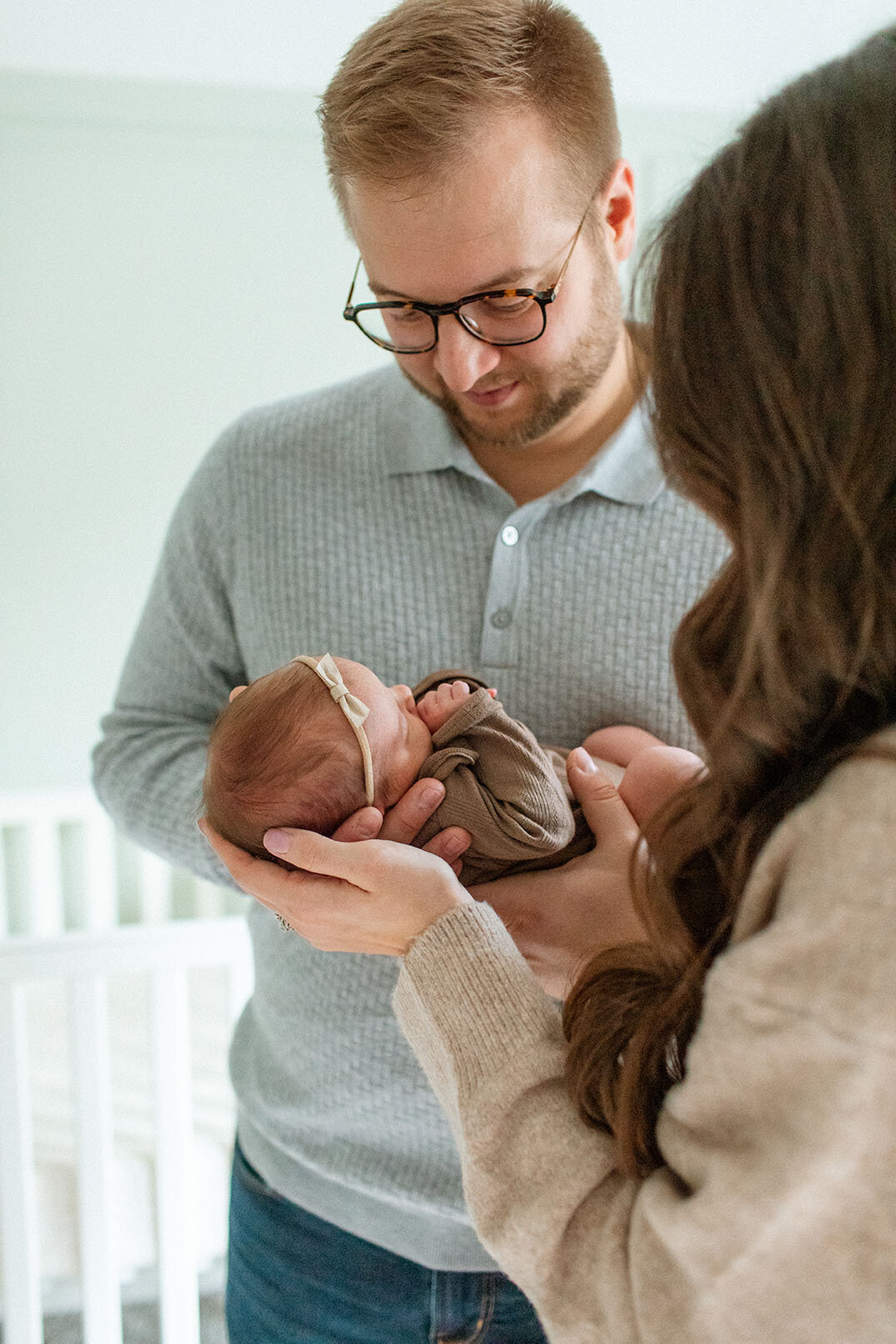 Father changing newborn baby's diaper - Sara James documents authentic parenting moments and daily newborn care during real-life lifestyle photography sessions in San Antonio Texas homes