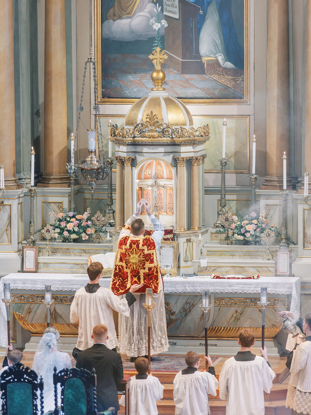 Elevation of the Host during traditional Latin Mass during Old St Marys wedding in Cincinnati
