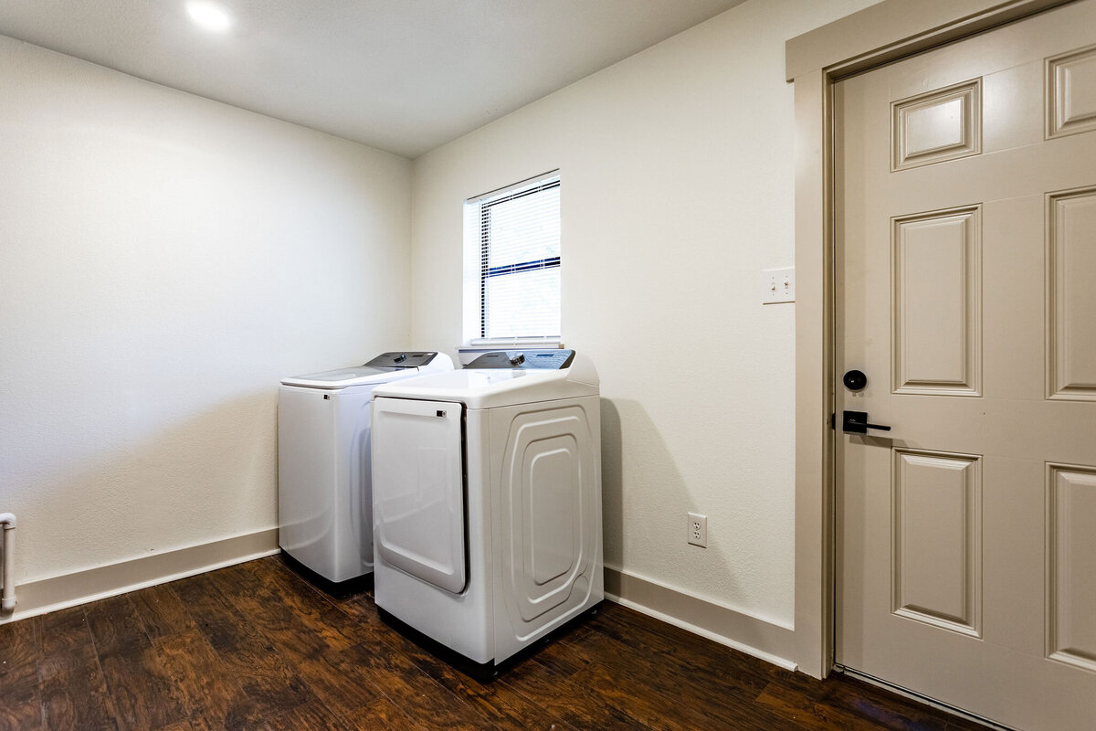 Spacious laundry area with washer and dryer at this 4-bedroom, 3.5 bathroom country house for 12 just 10 minutes from downtown Waco, TX.